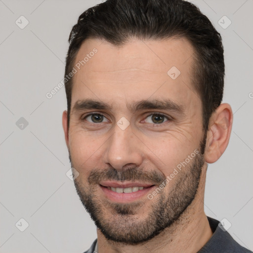 Joyful white adult male with short  brown hair and brown eyes