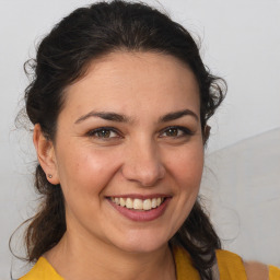 Joyful white young-adult female with medium  brown hair and brown eyes