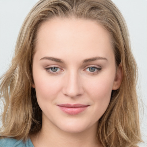 Joyful white young-adult female with long  brown hair and blue eyes