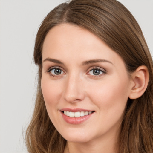 Joyful white young-adult female with long  brown hair and grey eyes