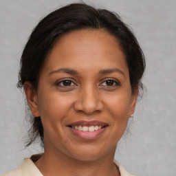 Joyful white adult female with medium  brown hair and brown eyes