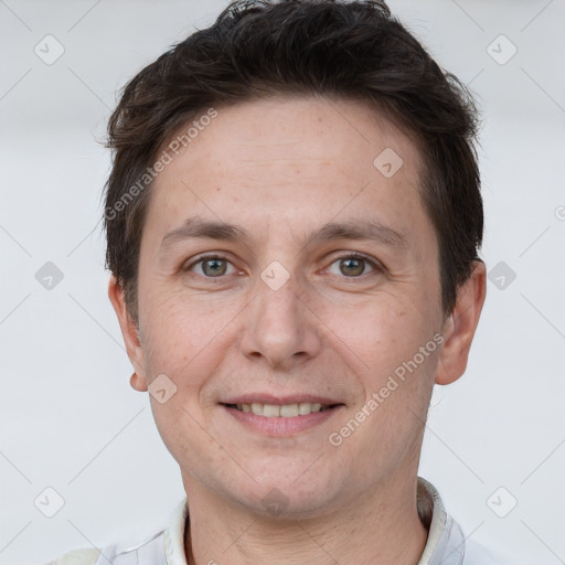 Joyful white adult male with short  brown hair and brown eyes