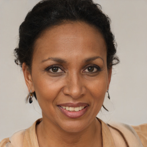 Joyful black adult female with short  brown hair and brown eyes