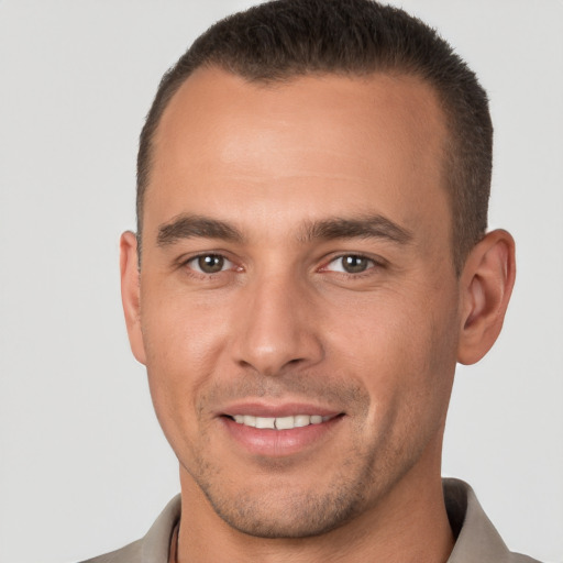 Joyful white young-adult male with short  brown hair and brown eyes