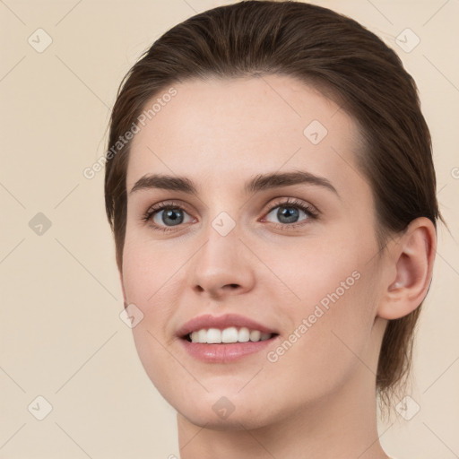 Joyful white young-adult female with medium  brown hair and grey eyes