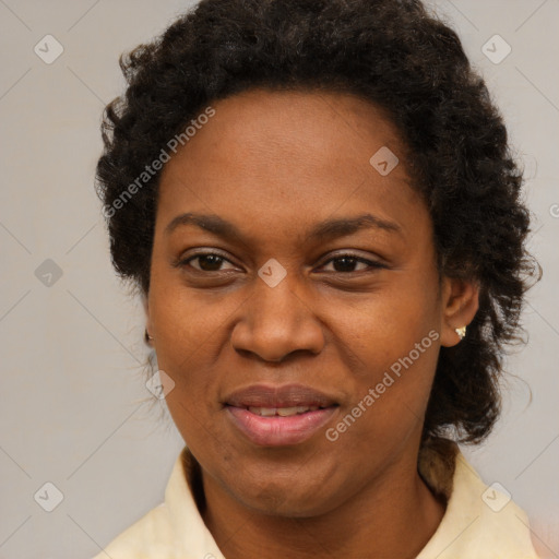 Joyful black adult female with medium  brown hair and brown eyes