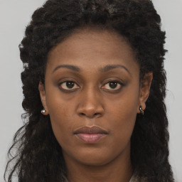 Neutral black young-adult female with long  brown hair and brown eyes