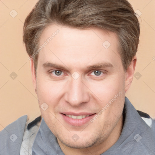 Joyful white adult male with short  brown hair and grey eyes