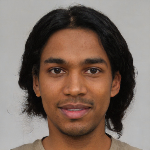 Joyful latino young-adult male with medium  black hair and brown eyes