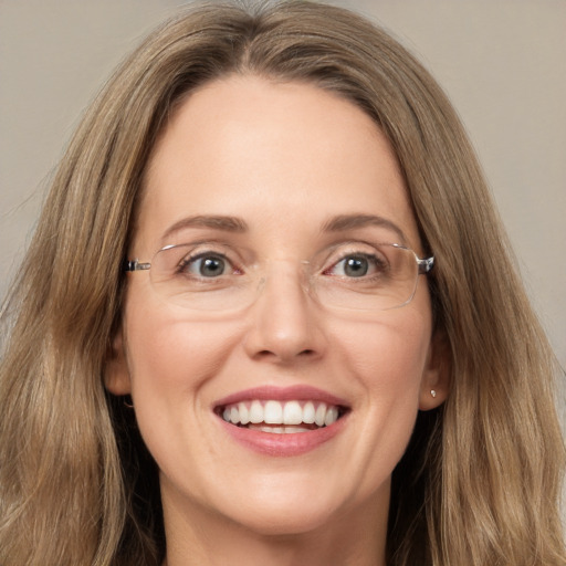 Joyful white adult female with long  brown hair and green eyes