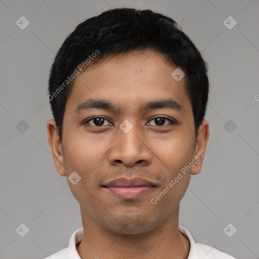 Joyful latino young-adult male with short  black hair and brown eyes