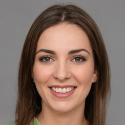 Joyful white young-adult female with long  brown hair and green eyes