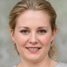 Joyful white young-adult female with medium  brown hair and blue eyes