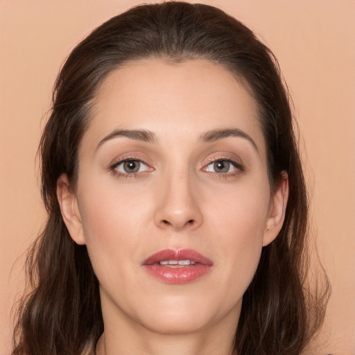 Joyful white young-adult female with long  brown hair and brown eyes