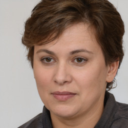 Joyful white adult female with medium  brown hair and brown eyes