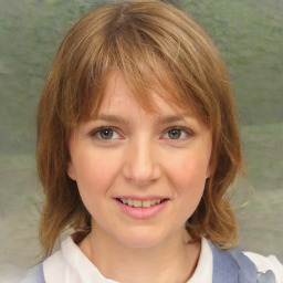 Joyful white child female with medium  brown hair and blue eyes