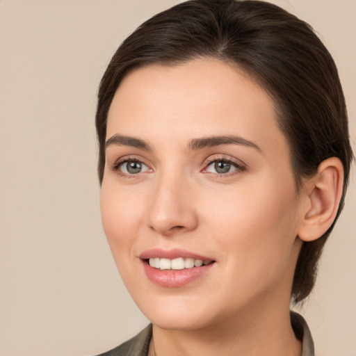 Joyful white young-adult female with medium  brown hair and brown eyes