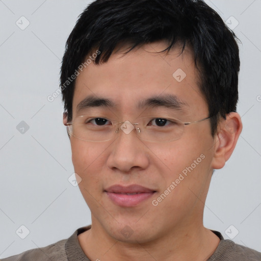 Joyful asian young-adult male with short  black hair and brown eyes