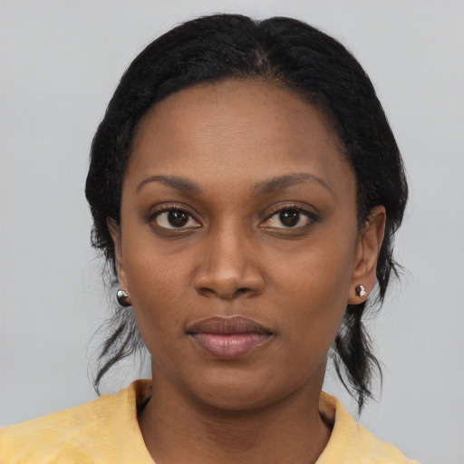 Joyful black young-adult female with medium  black hair and brown eyes
