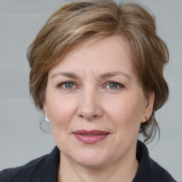 Joyful white adult female with medium  brown hair and grey eyes