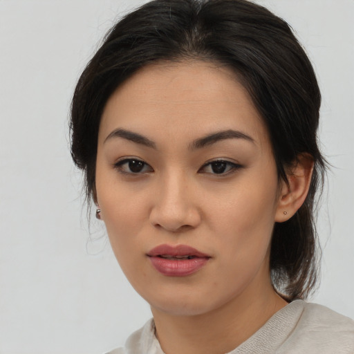 Joyful asian young-adult female with medium  brown hair and brown eyes