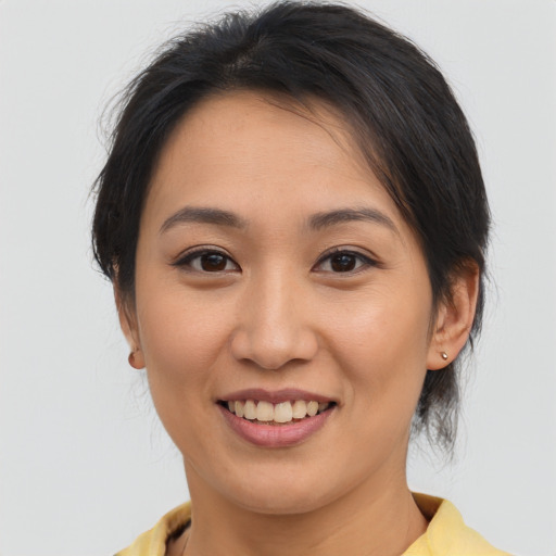 Joyful asian young-adult female with medium  brown hair and brown eyes