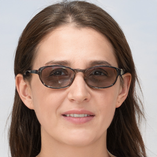 Joyful white young-adult female with medium  brown hair and blue eyes