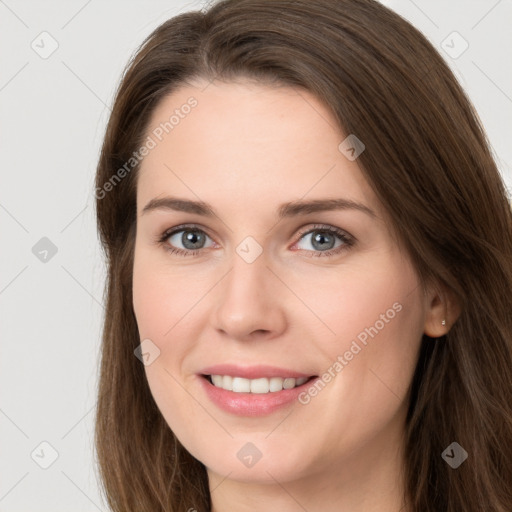 Joyful white young-adult female with long  brown hair and grey eyes