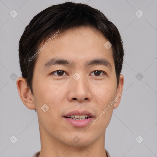 Joyful asian young-adult male with short  brown hair and brown eyes