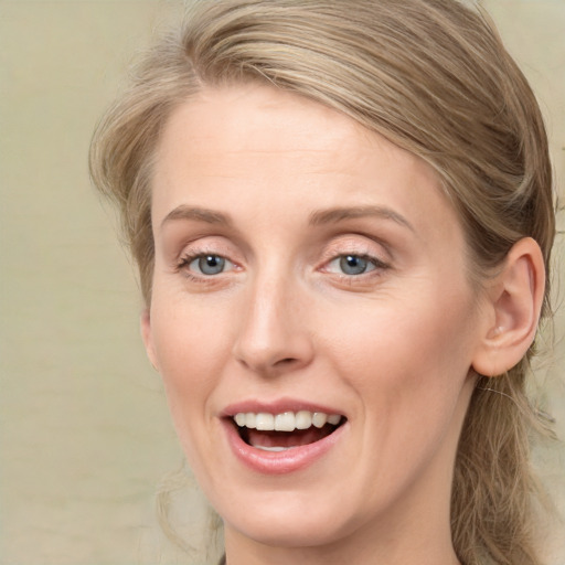 Joyful white young-adult female with medium  brown hair and blue eyes