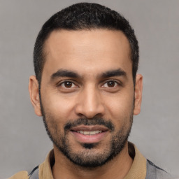 Joyful latino young-adult male with short  black hair and brown eyes