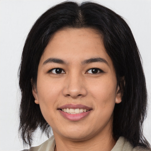 Joyful asian young-adult female with medium  black hair and brown eyes