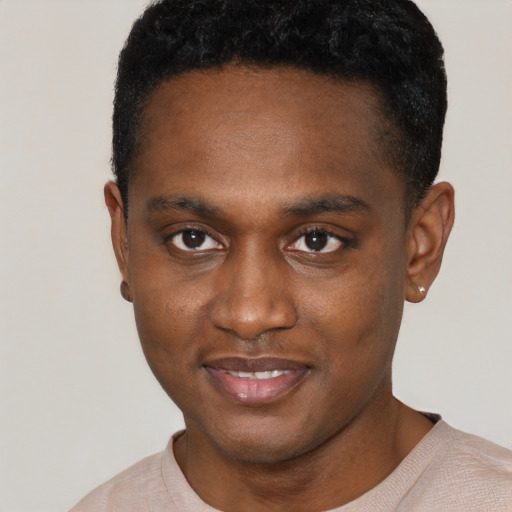 Joyful black young-adult male with short  brown hair and brown eyes