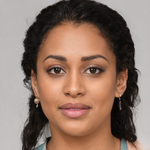 Joyful latino young-adult female with long  brown hair and brown eyes