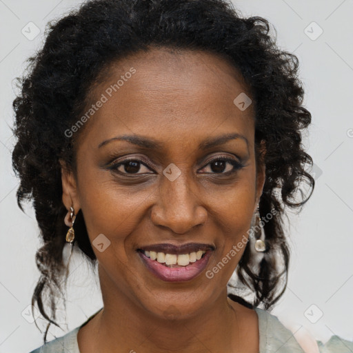 Joyful black adult female with medium  brown hair and brown eyes