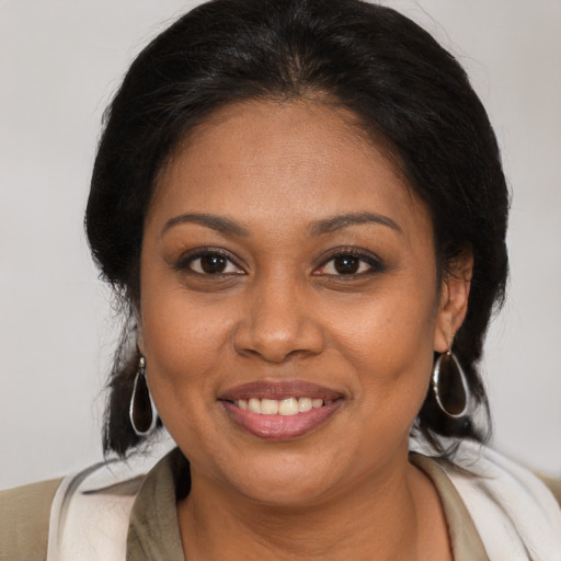 Joyful black young-adult female with medium  brown hair and brown eyes