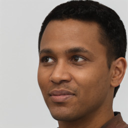 Joyful black young-adult male with short  black hair and brown eyes