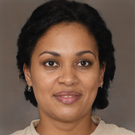 Joyful black adult female with short  brown hair and brown eyes