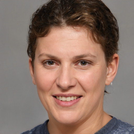 Joyful white adult female with short  brown hair and grey eyes