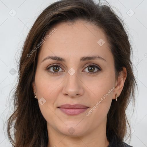 Joyful white adult female with long  brown hair and brown eyes