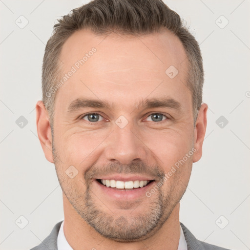 Joyful white adult male with short  brown hair and brown eyes