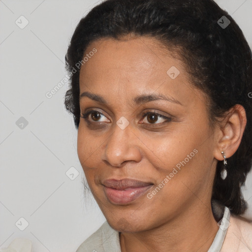 Joyful black adult female with medium  brown hair and brown eyes