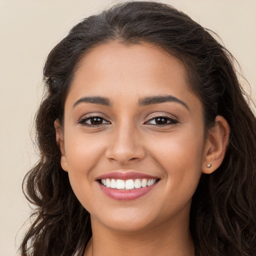 Joyful white young-adult female with long  brown hair and brown eyes