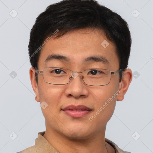 Joyful asian young-adult male with short  brown hair and brown eyes