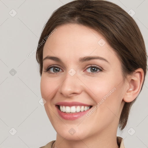 Joyful white young-adult female with medium  brown hair and grey eyes