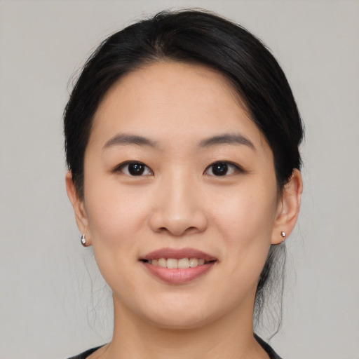 Joyful asian young-adult female with medium  black hair and brown eyes