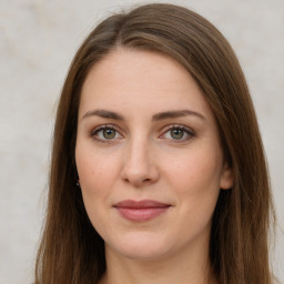 Joyful white young-adult female with long  brown hair and green eyes