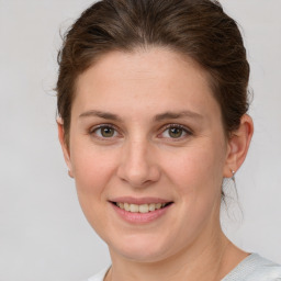 Joyful white young-adult female with short  brown hair and grey eyes