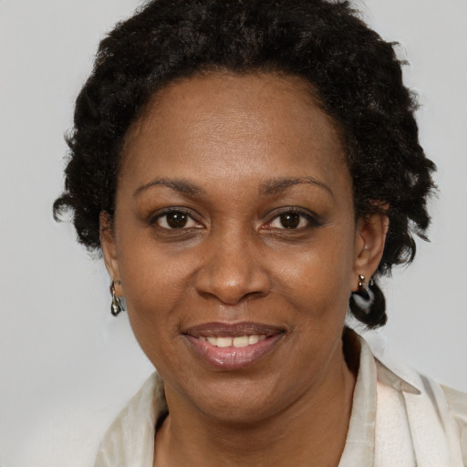 Joyful black adult female with short  brown hair and brown eyes