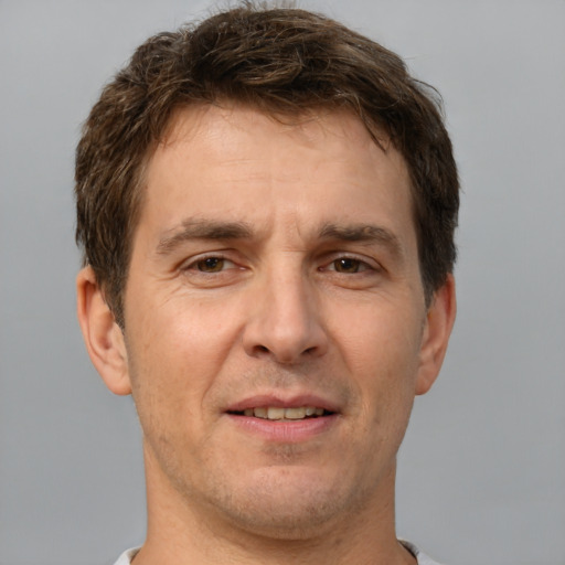 Joyful white adult male with short  brown hair and brown eyes